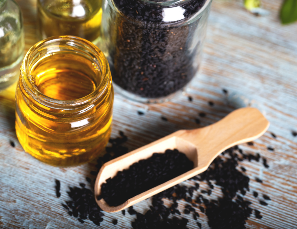 the benefits of black seed oil can't be seen with the naked eye in this photo of both the seeds and the oil